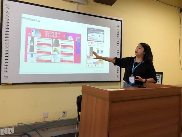 A person standing in front of a screenDescription automatically generated with medium confidence